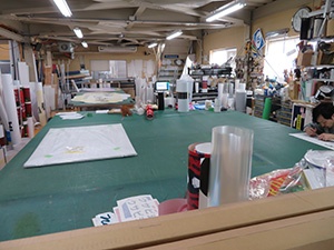 Processing table for applying finishing touches to printouts. Company characterized by quick response capabilities.